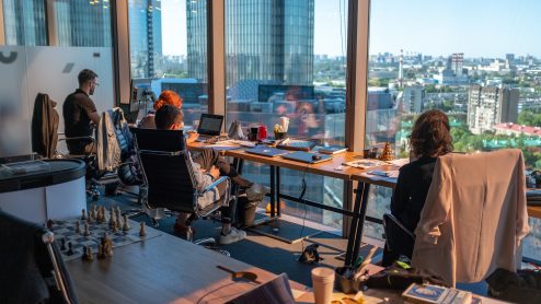 Office workers at desks overlooking a cityscape