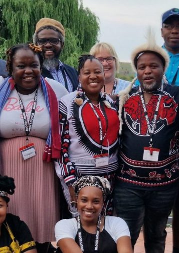 A group of South African THPs and allies laugh, smile, and pose for a photo