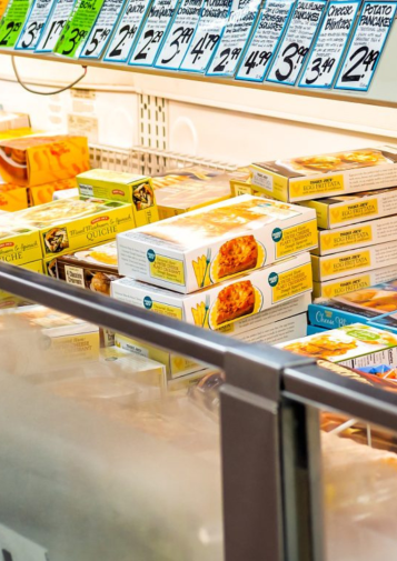An array of frozen foods in an open refrigerator