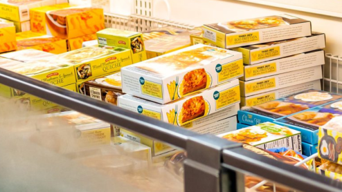 An array of frozen foods in an open refrigerator