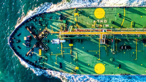 A large ship plows through the water