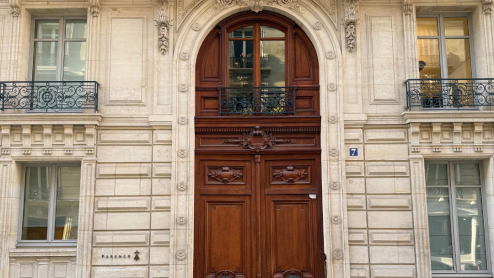 An enormous door in a Parisian building