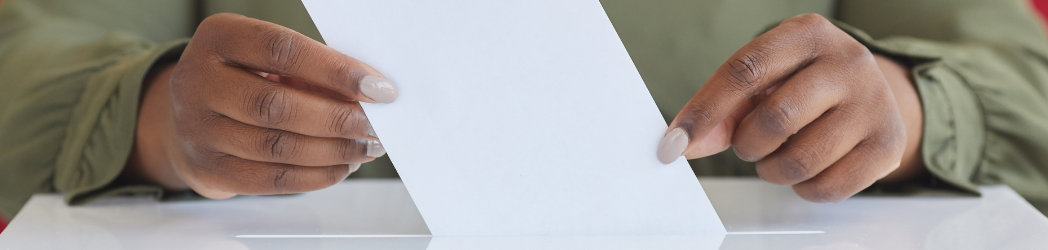 Hands submitting a piece of paper to a tip box