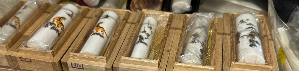 A row of ivory hanko decorated with tigers and dragons