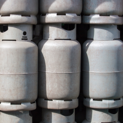 A stack of unlabeled gas canisters