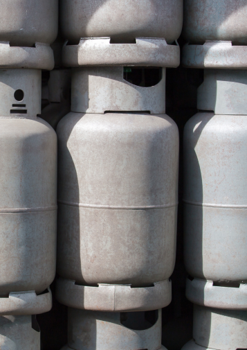 A stack of unlabeled gas canisters