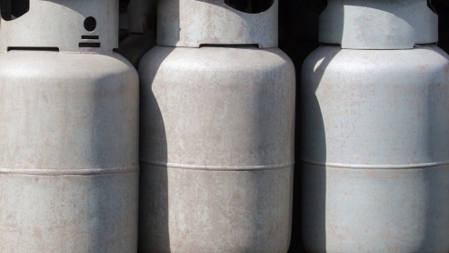 A stack of unlabeled gas canisters
