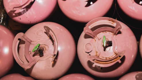 Collection of pink R-410A refrigerant cylinders