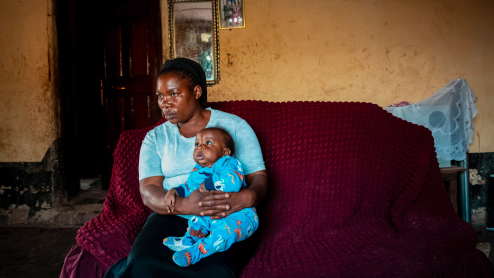 Concerned mother holding her baby in the DRC