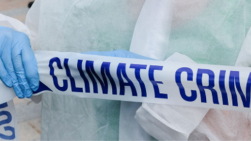 Activist in medical garb holds up police-style tape reading Climate Crime Scene