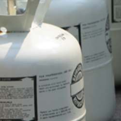 Closeup of a row of refrigerant containers