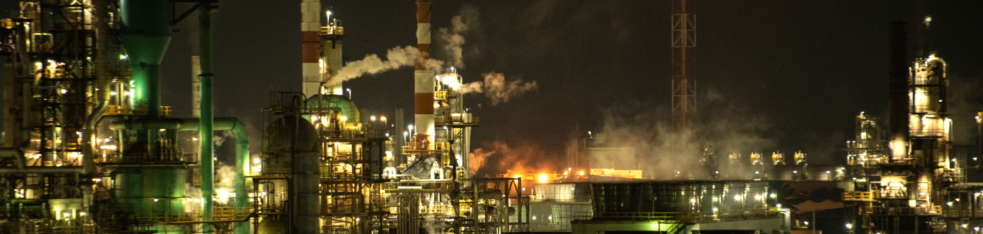 Emissions billow from a facility at night